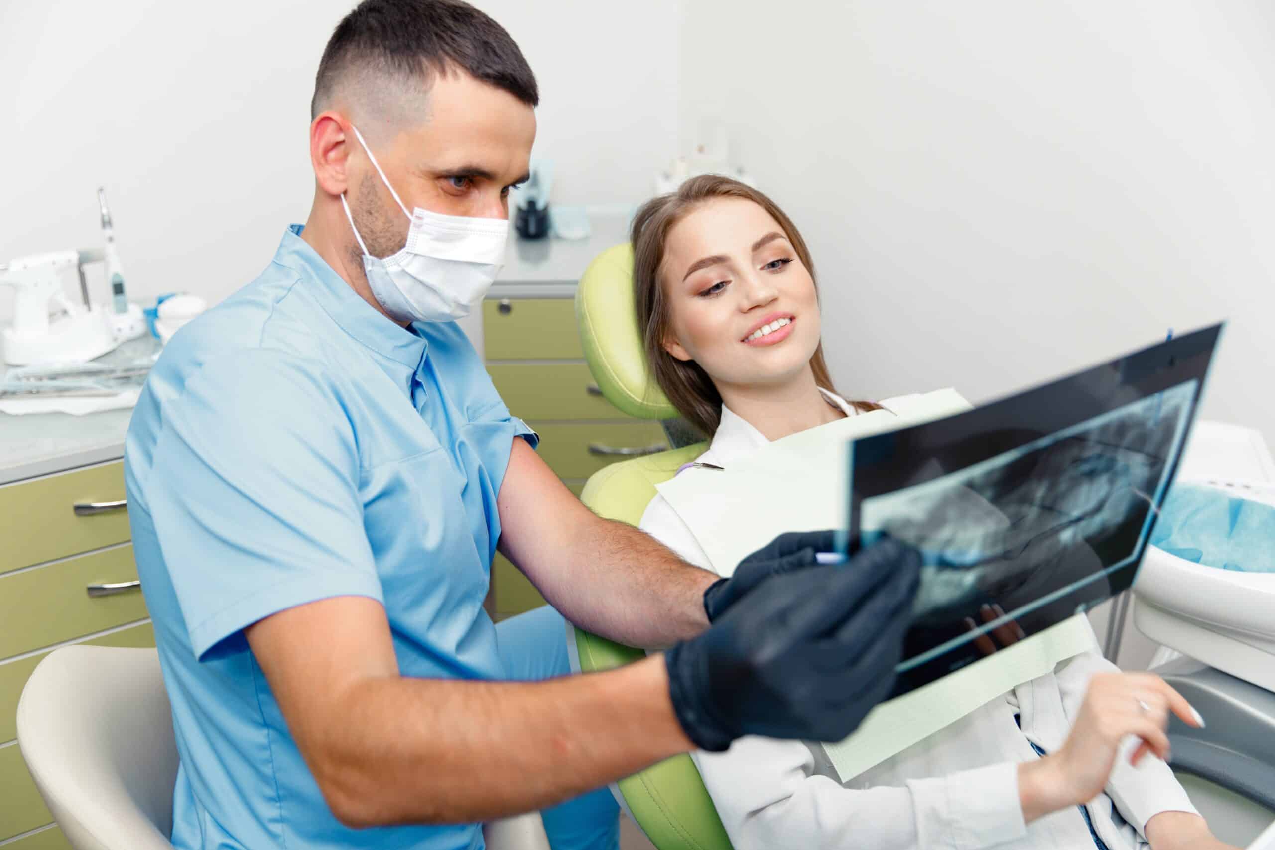 Top Dentist Marlton reviewing panoramic X-ray during a dental consultation at a modern dentistry clinic